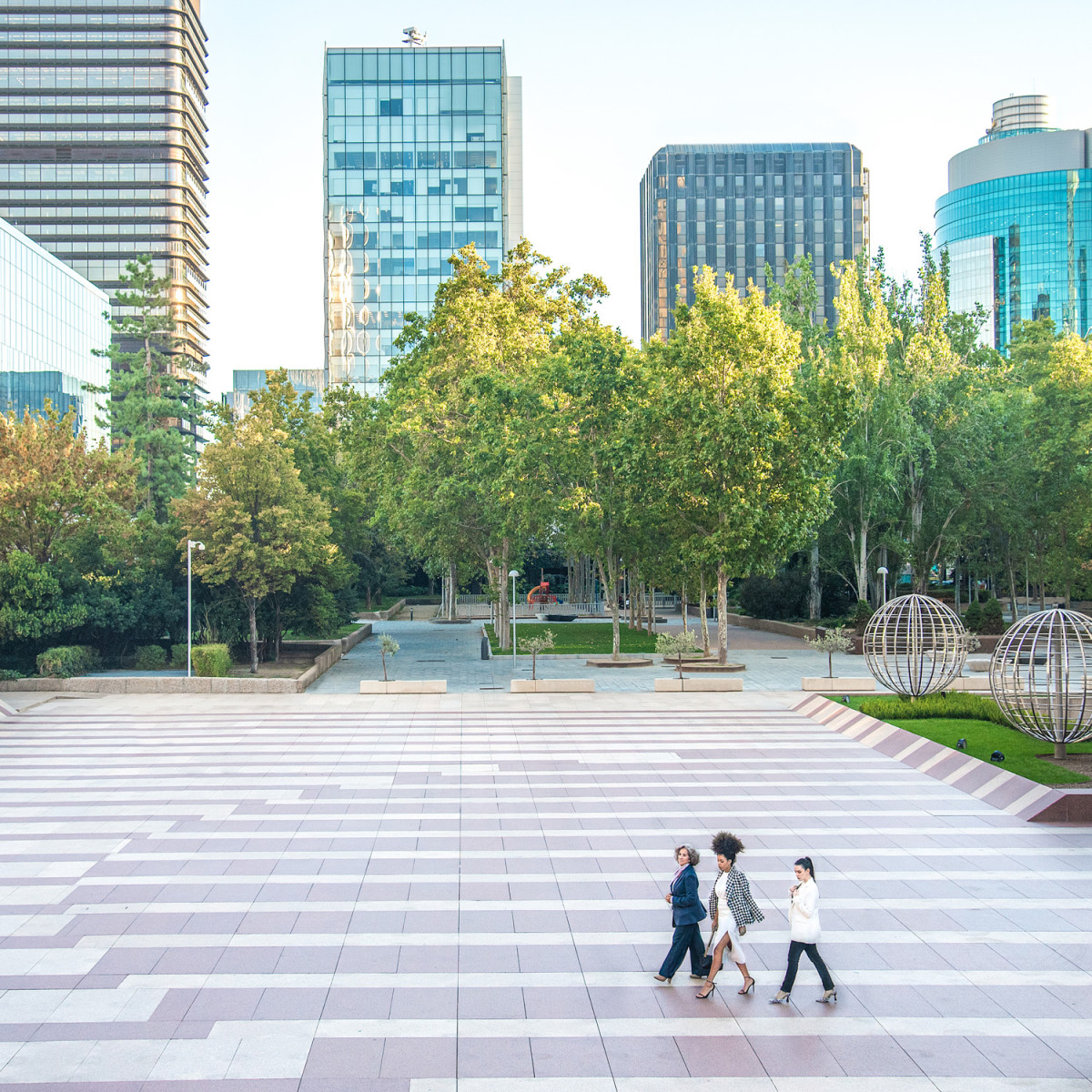general-view-of-women-walking-park-and-skysrcaper